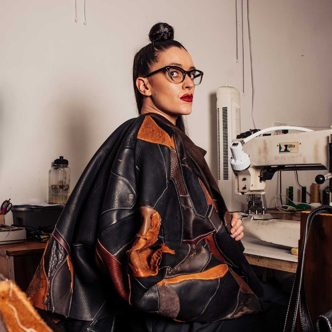 image of Lauren Broxton sitting down with leather cape
